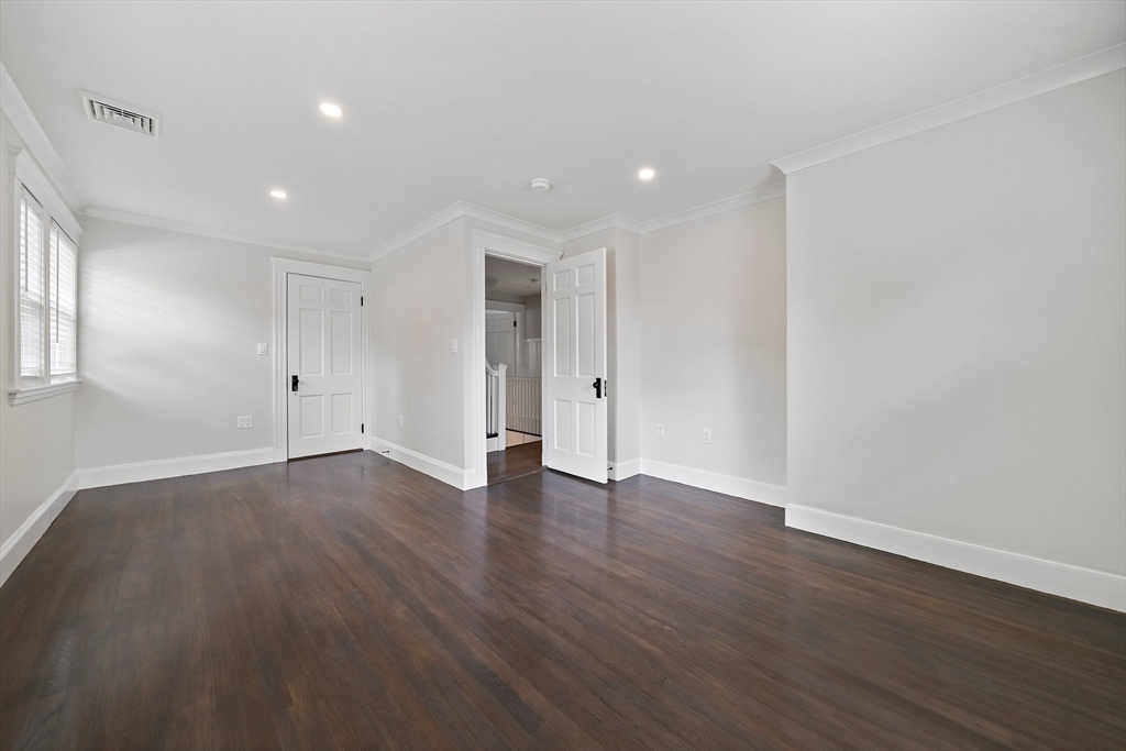 37 Wolcott Road, Unit 37 Brookline, MA 02467 - Photo 20 of 40 a view of an empty room with wooden floor