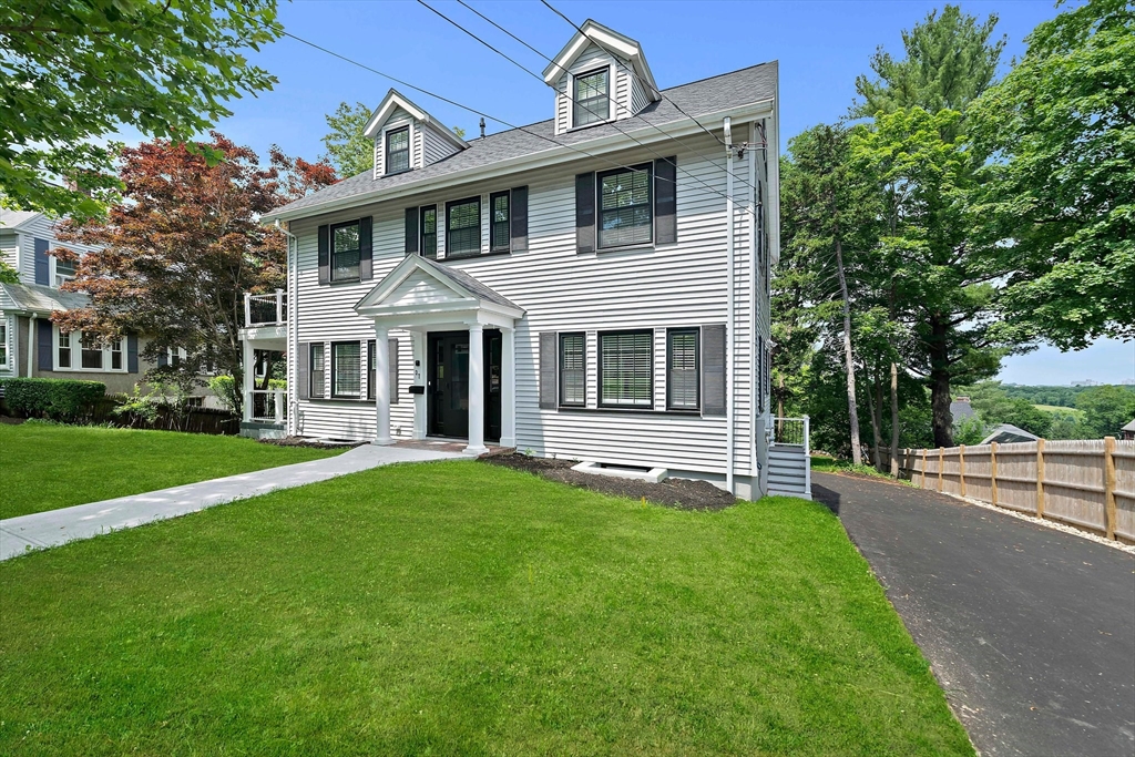 37 Wolcott Road, Unit 37 Brookline, MA 02467 - Photo 2 of 40 a front view of a house with a yard