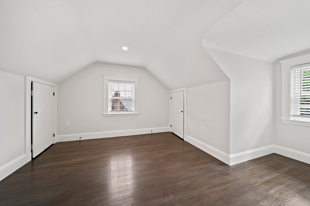 37 Wolcott Road, Unit 37 Brookline, MA 02467 - Photo 24 of 40 an empty room with wooden floor and windows