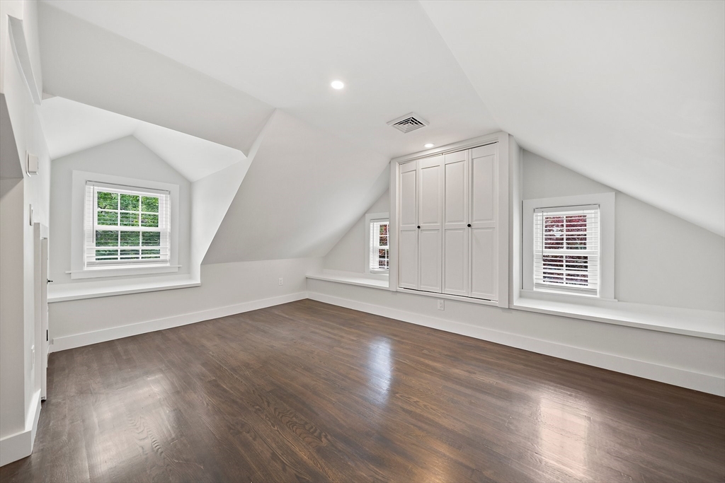 37 Wolcott Road, Unit 37 Brookline, MA 02467 - Photo 25 of 40 an empty room with wooden floor and windows