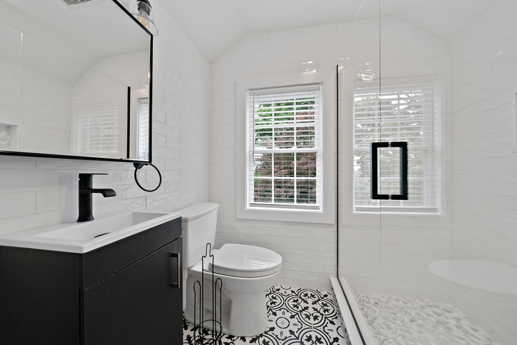 37 Wolcott Road, Unit 37 Brookline, MA 02467 - Photo 26 of 40 a bathroom with a toilet a sink and mirror