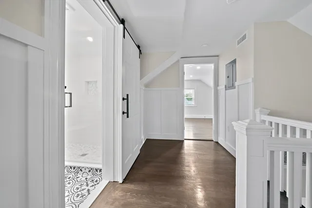 a view of an entryway with wooden floor