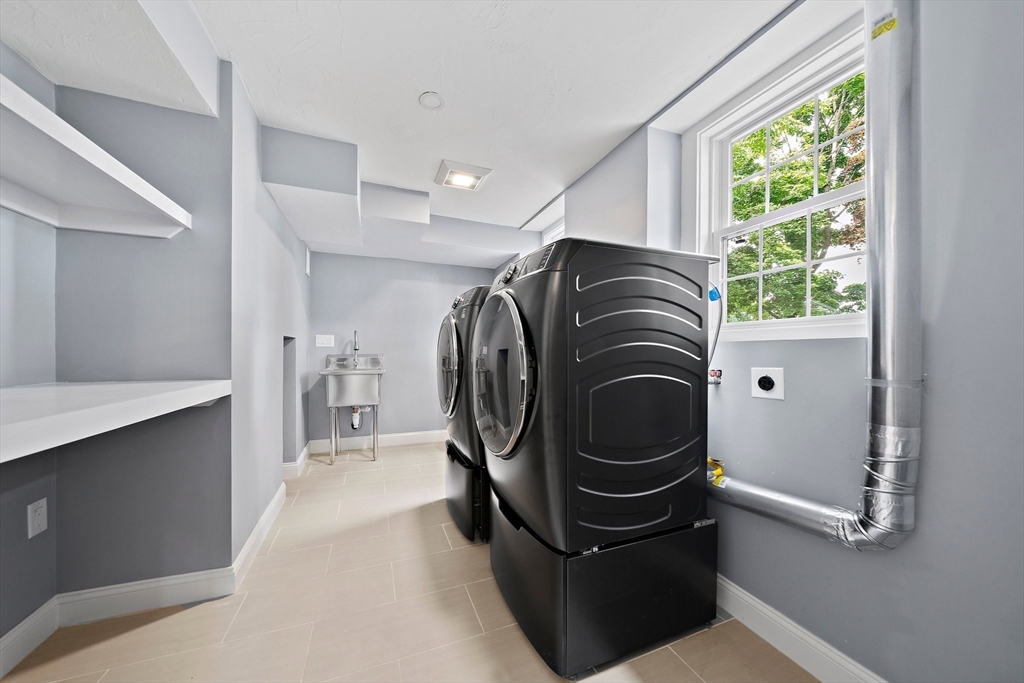37 Wolcott Road, Unit 37 Brookline, MA 02467 - Photo 32 of 40 a utility room with wooden floor washer and dryer