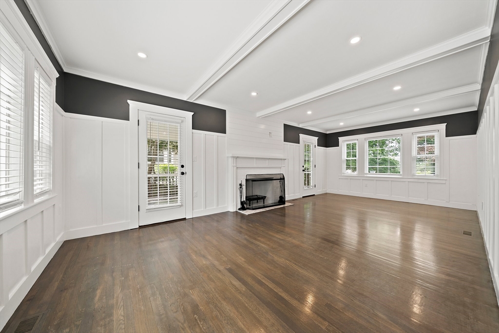 37 Wolcott Road, Unit 37 Brookline, MA 02467 - Photo 4 of 40 a view of an empty room with wooden floor and a window