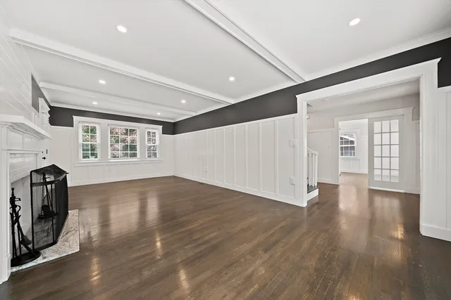 a view of a livingroom with wooden floor and a window