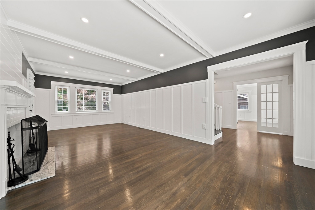 37 Wolcott Road, Unit 37 Brookline, MA 02467 - Photo 5 of 40 a view of a livingroom with wooden floor and a window