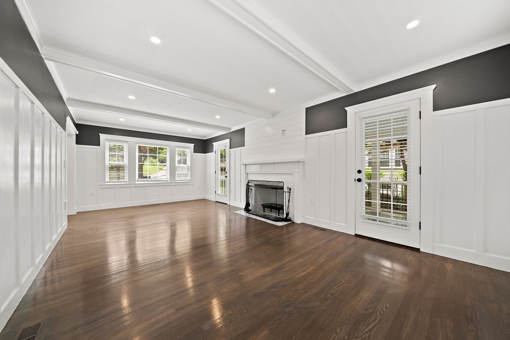 37 Wolcott Road, Unit 37 Brookline, MA 02467 - Photo 6 of 40 a view of an empty room with wooden floor and a window