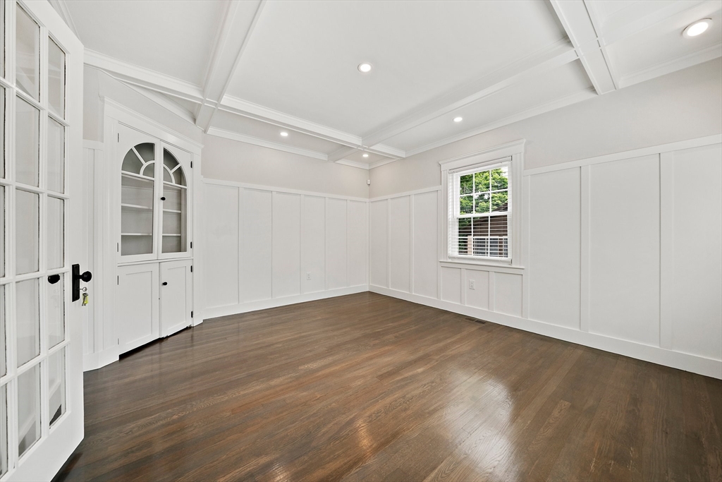 37 Wolcott Road, Unit 37 Brookline, MA 02467 - Photo 7 of 40 an empty room with wooden floor and windows