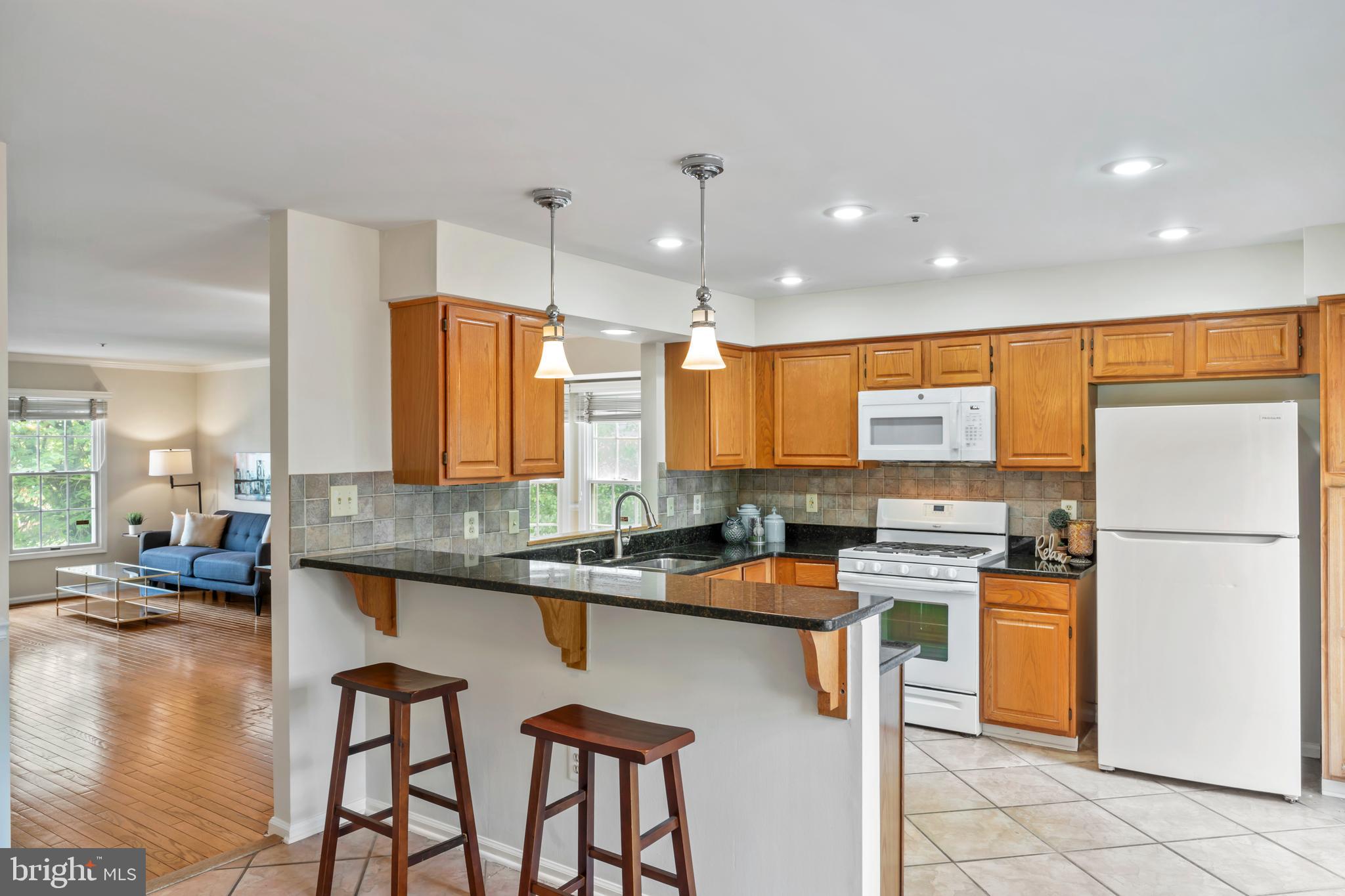 7850 Blue Gray Circle Manassas, VA 20109 - Photo 11 of 42 a kitchen with stainless steel appliances granite countertop counter space a sink and a refrigerator