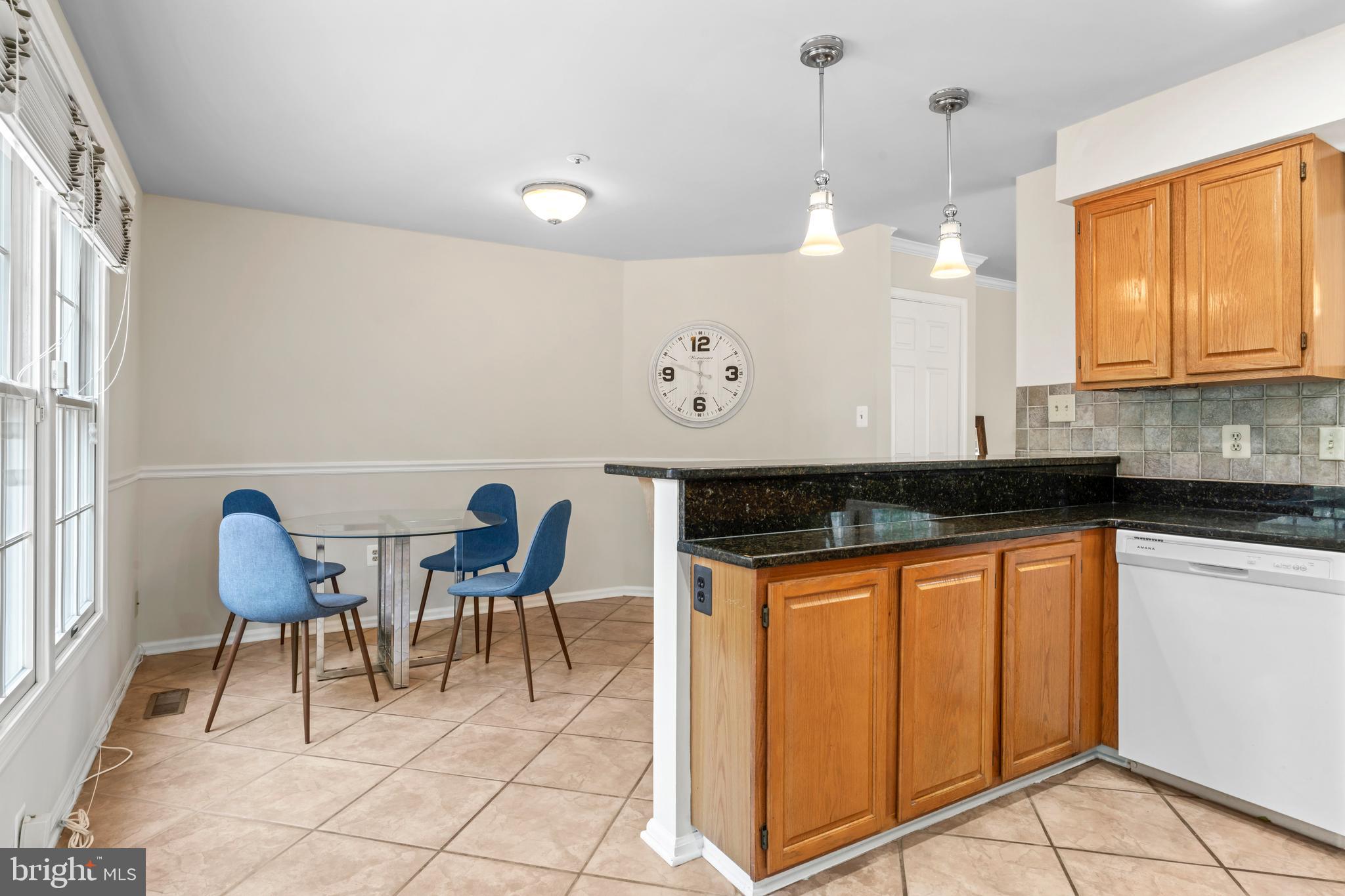 7850 Blue Gray Circle Manassas, VA 20109 - Photo 12 of 42 a kitchen with granite countertop cabinets and chairs