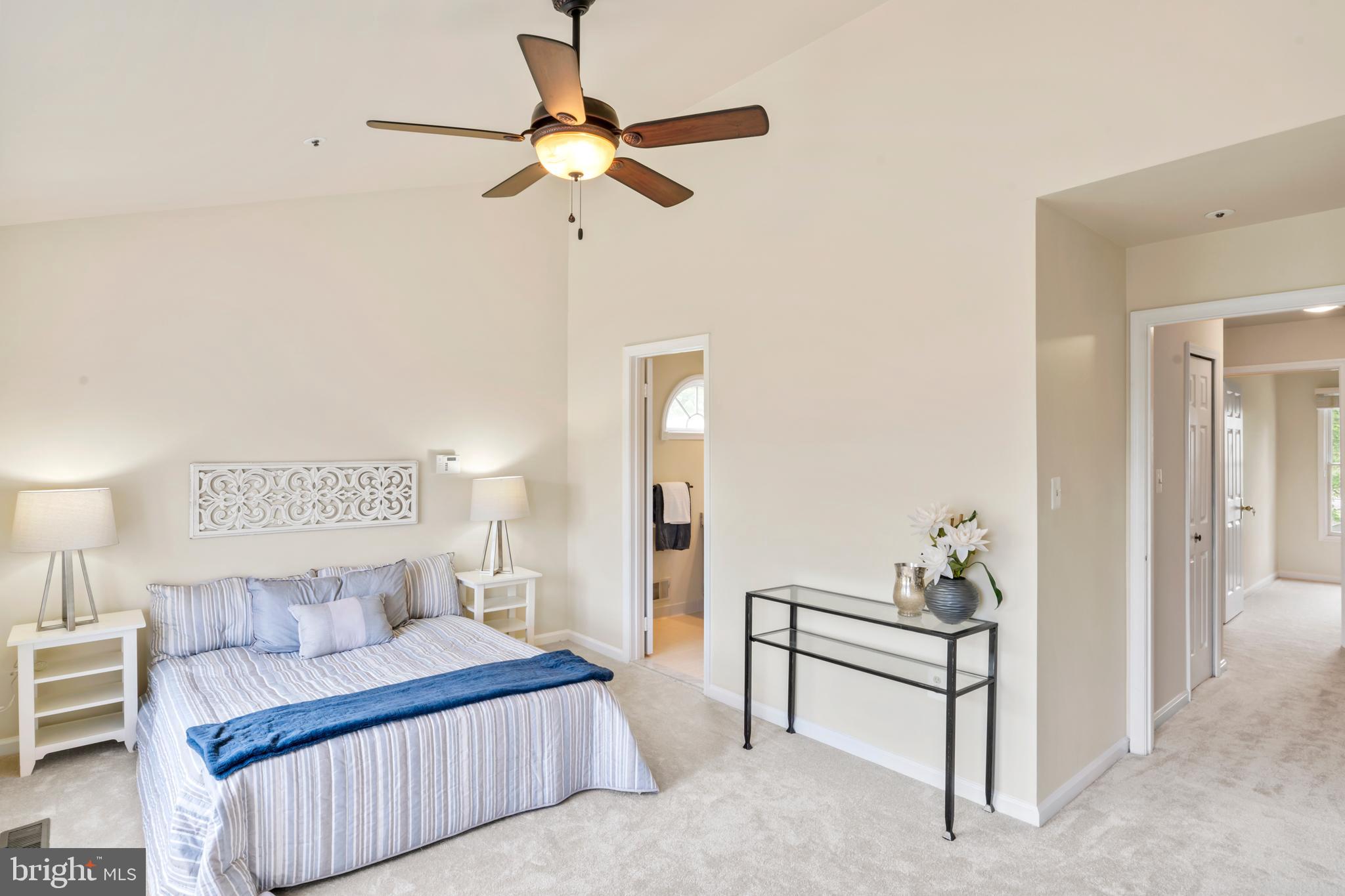 7850 Blue Gray Circle Manassas, VA 20109 - Photo 17 of 42 a bedroom with a bed and a chandelier