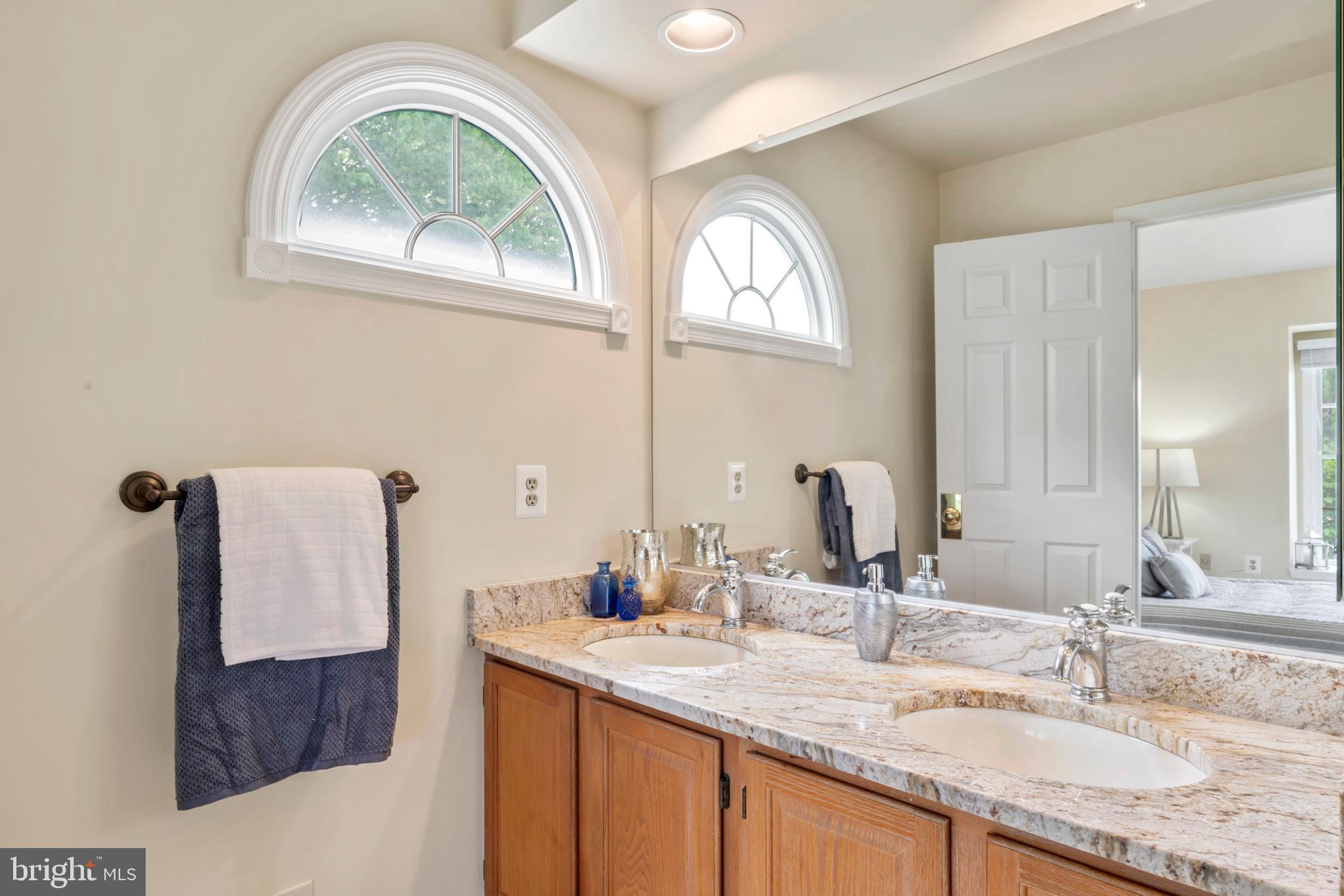 7850 Blue Gray Circle Manassas, VA 20109 - Photo 18 of 42 a bathroom with a granite countertop a sink and a mirror