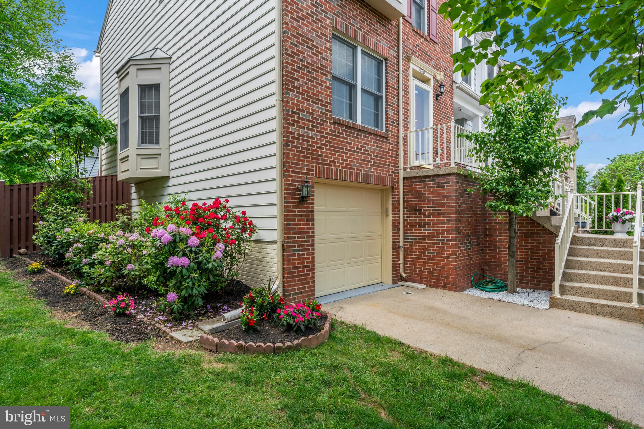 7850 Blue Gray Circle Manassas, VA 20109 - Photo 2 of 42 a view of a house with a yard and garden