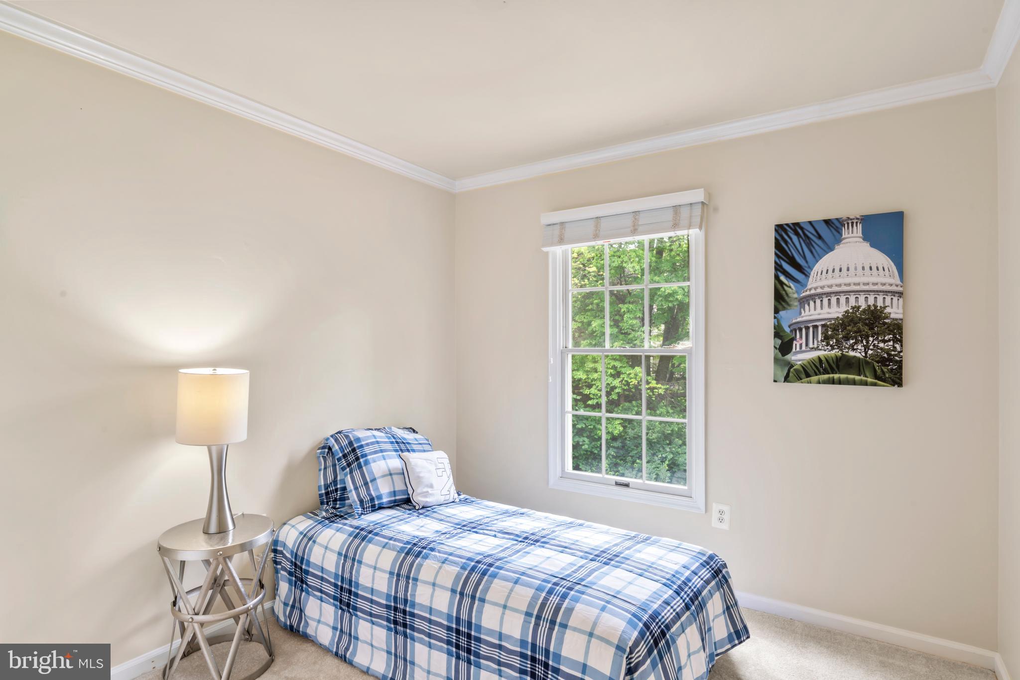 7850 Blue Gray Circle Manassas, VA 20109 - Photo 22 of 42 a bedroom with a bed and a lamp next to a window