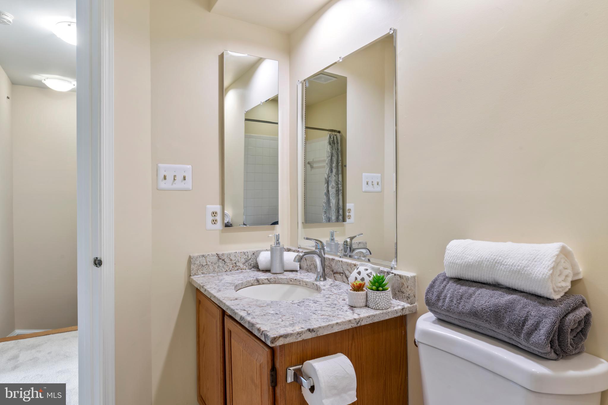 7850 Blue Gray Circle Manassas, VA 20109 - Photo 23 of 42 a en suite bathroom with a granite countertop sink and a mirror