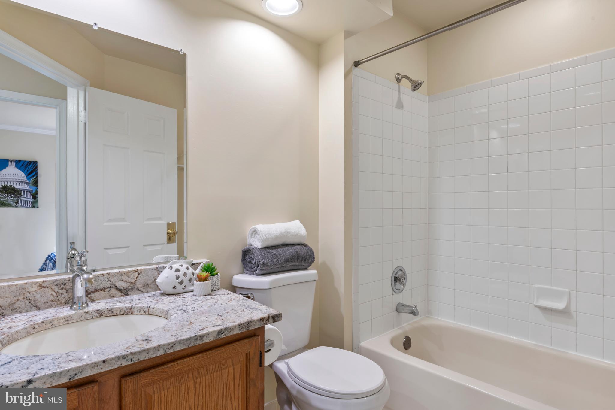 7850 Blue Gray Circle Manassas, VA 20109 - Photo 24 of 42 a bathroom with a granite countertop sink toilet and shower