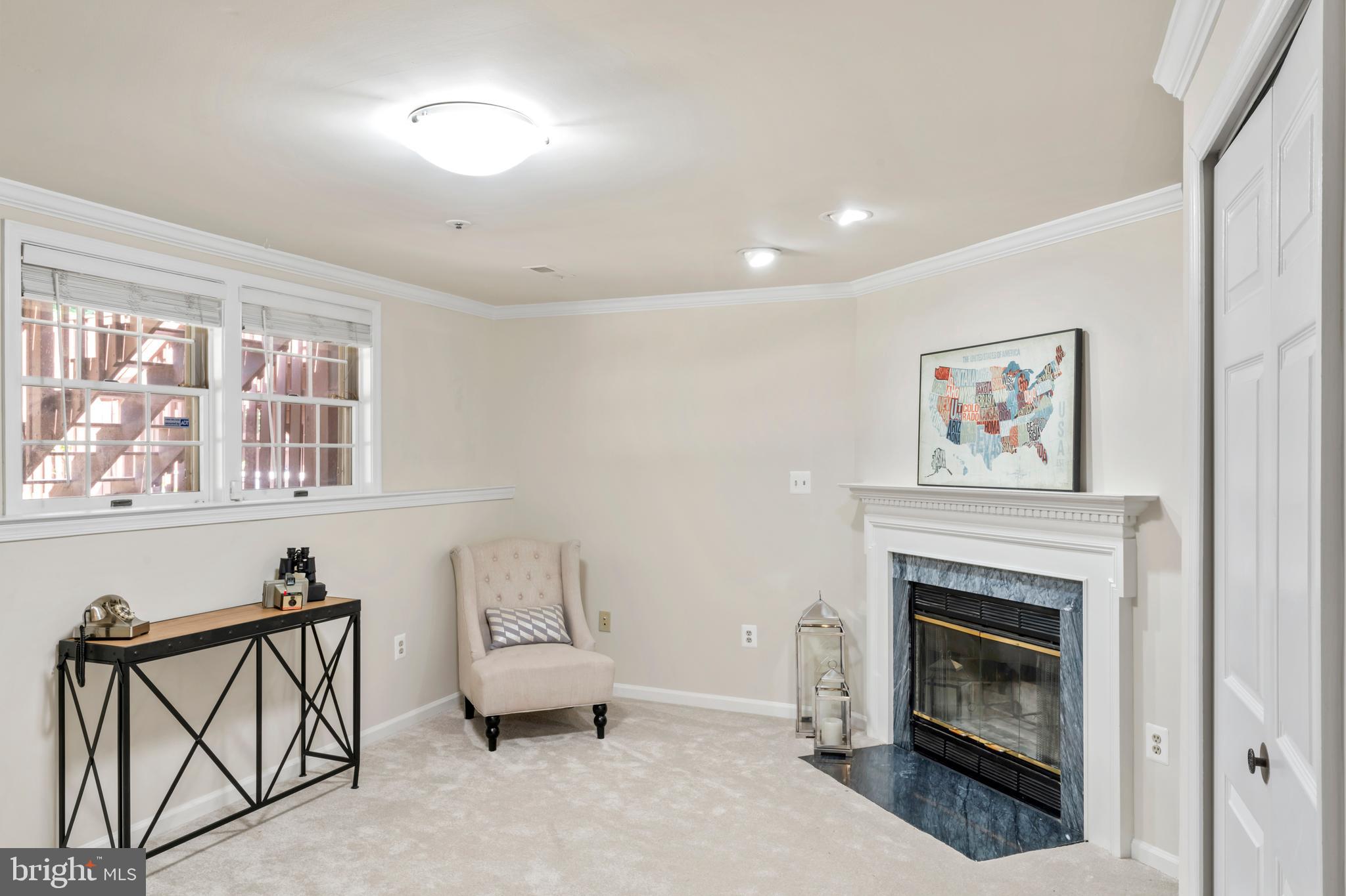 7850 Blue Gray Circle Manassas, VA 20109 - Photo 27 of 42 a living room with furniture a fireplace and a window