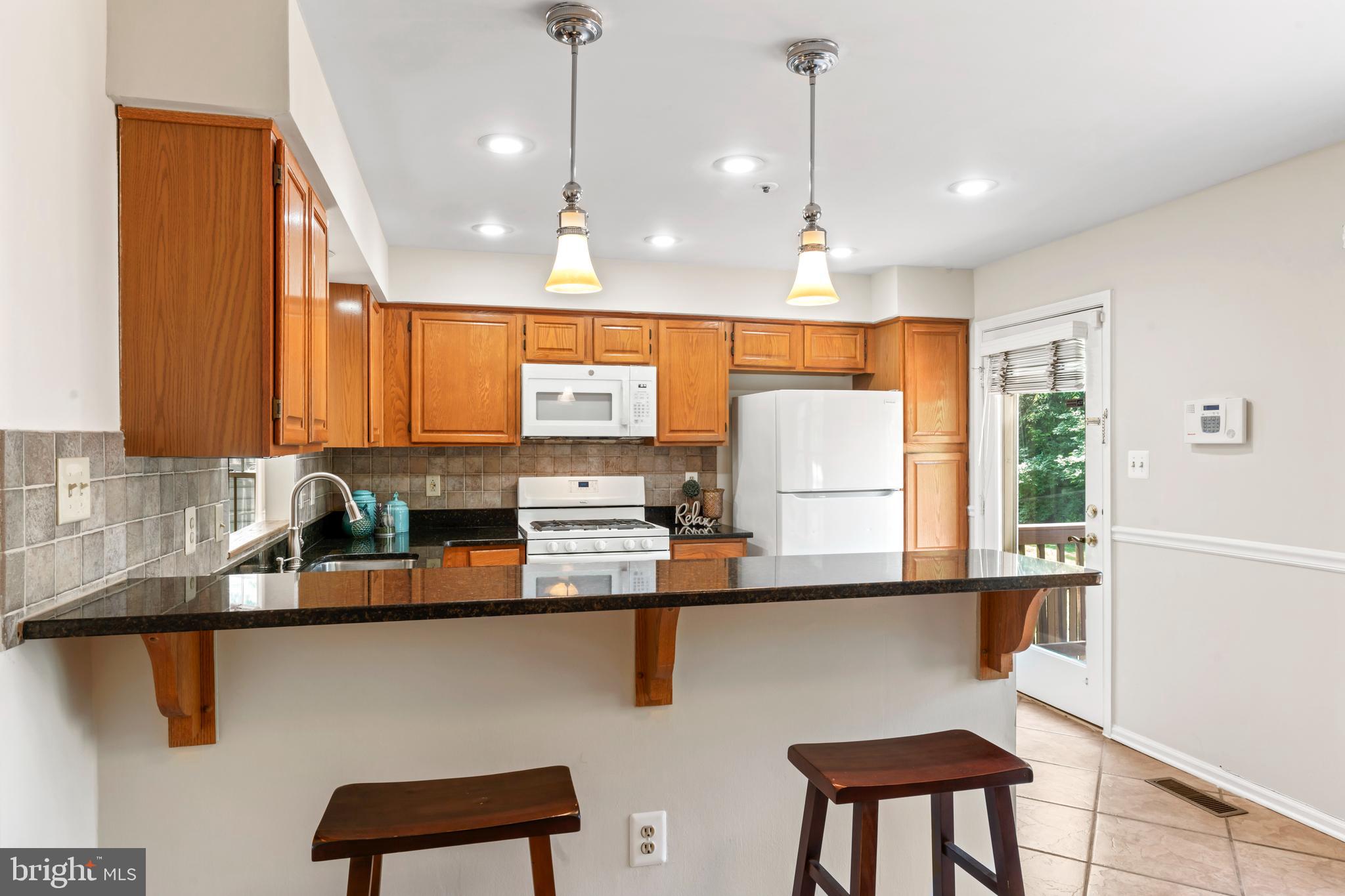 7850 Blue Gray Circle Manassas, VA 20109 - Photo 10 of 42 a kitchen with stainless steel appliances kitchen island a large window in it and kitchen island