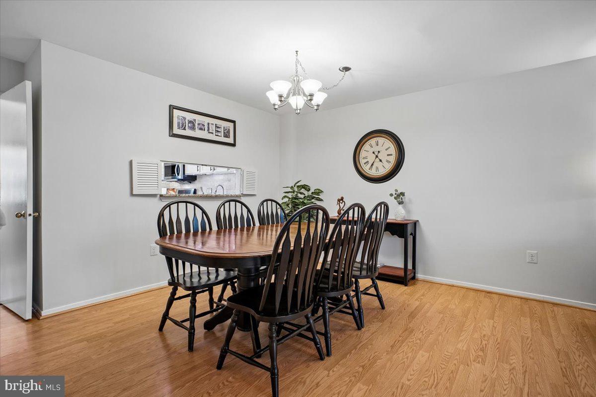11514 Sunder Court Reston, VA 20190 - Photo 11 of 81 a view of a dining room with furniture wooden floor and a table