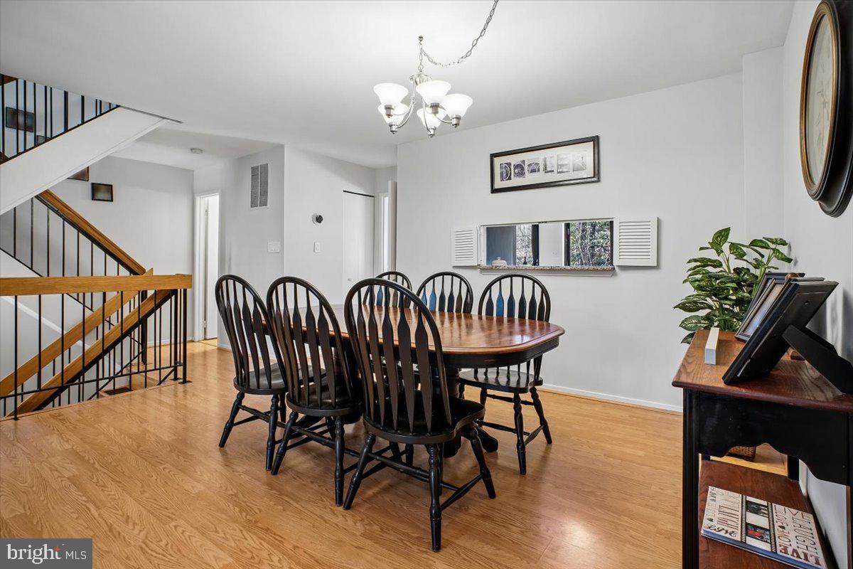 11514 Sunder Court Reston, VA 20190 - Photo 12 of 81 a view of a dining room with furniture and wooden floor