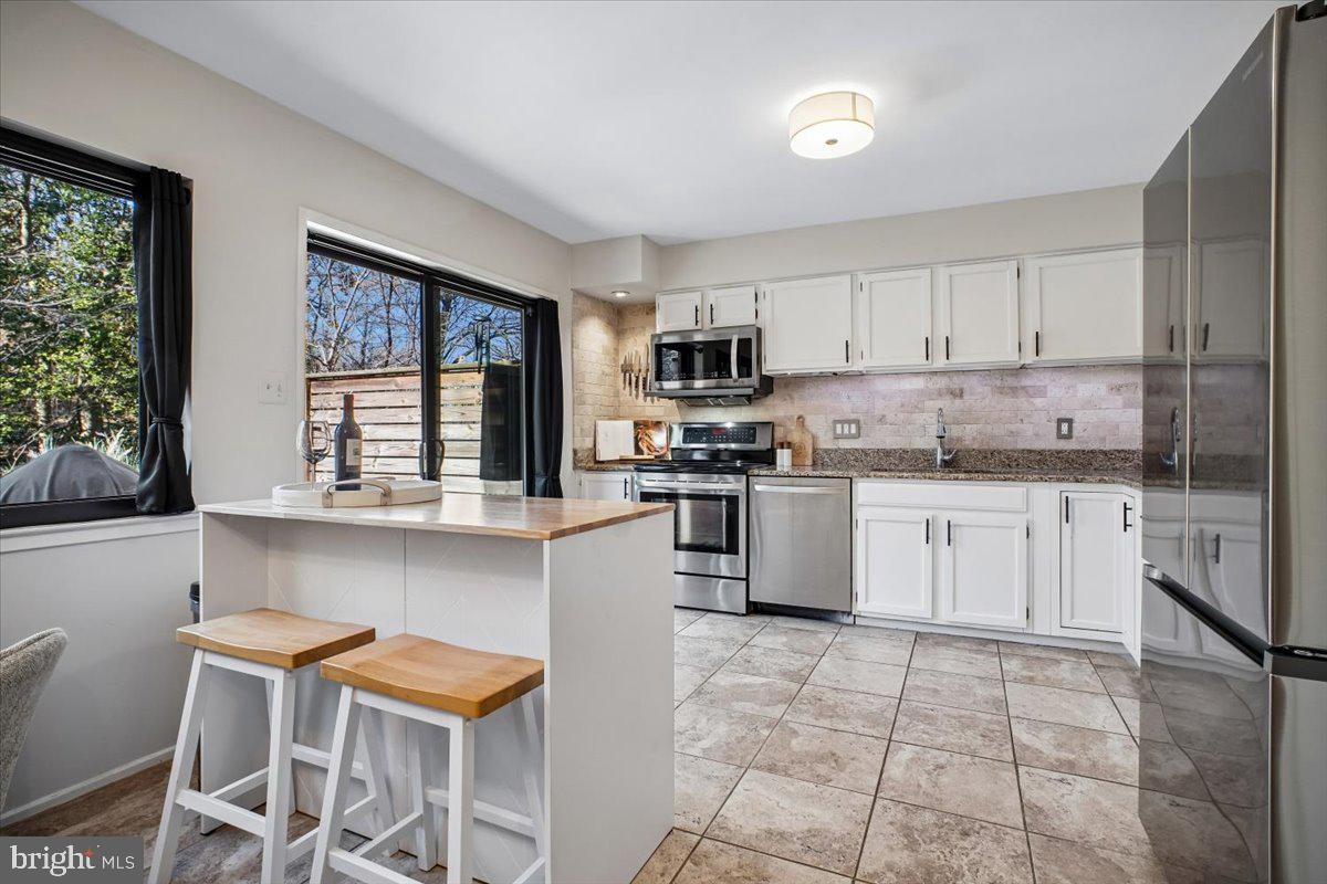 11514 Sunder Court Reston, VA 20190 - Photo 13 of 81 a kitchen with a stove a sink a microwave and cabinets
