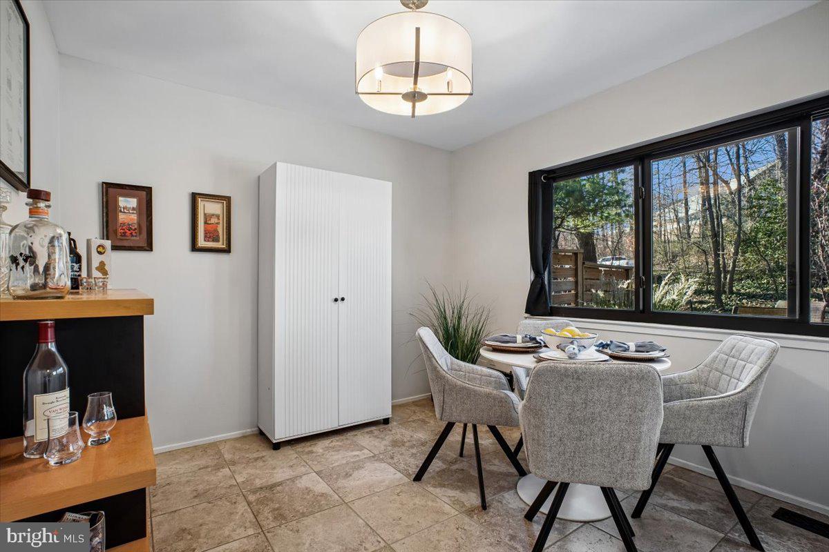 11514 Sunder Court Reston, VA 20190 - Photo 17 of 81 a dining room with furniture a window and a chandelier