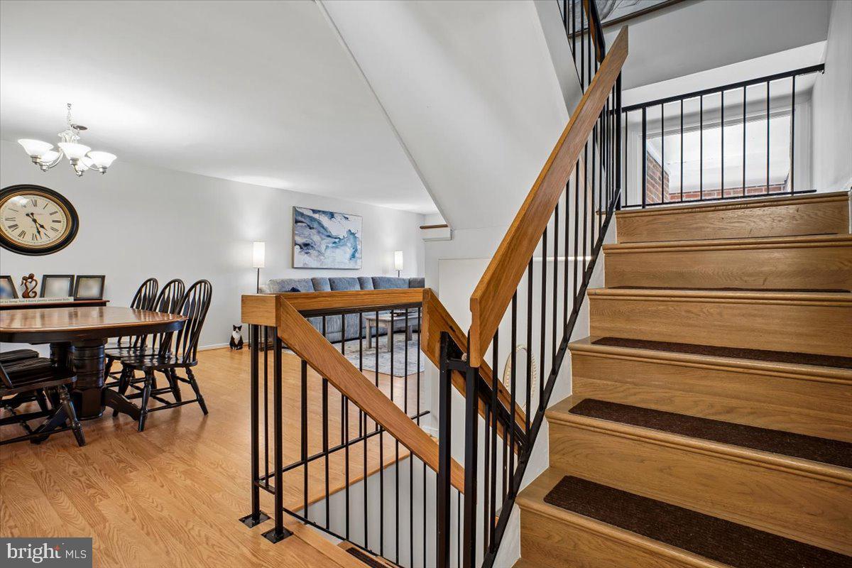 11514 Sunder Court Reston, VA 20190 - Photo 21 of 81 a view of a hallway with wooden floor and furniture