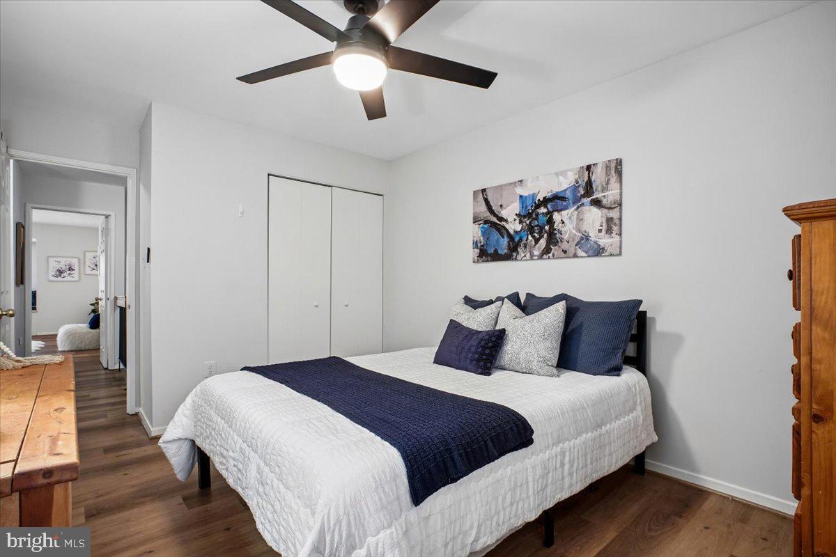 11514 Sunder Court Reston, VA 20190 - Photo 30 of 81 a bedroom with a large bed and a chandelier