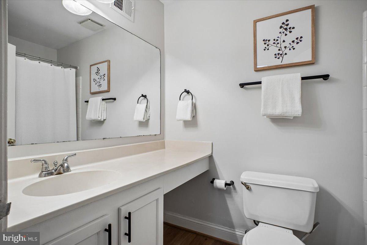 11514 Sunder Court Reston, VA 20190 - Photo 32 of 81 a bathroom with a sink mirror vanity and toilet