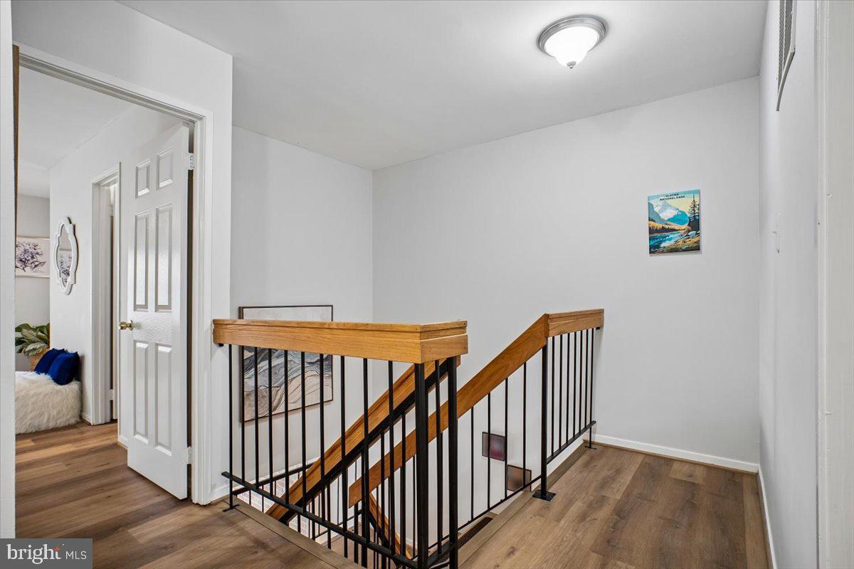 11514 Sunder Court Reston, VA 20190 - Photo 33 of 81 a view of a hallway with wooden floor and entryway