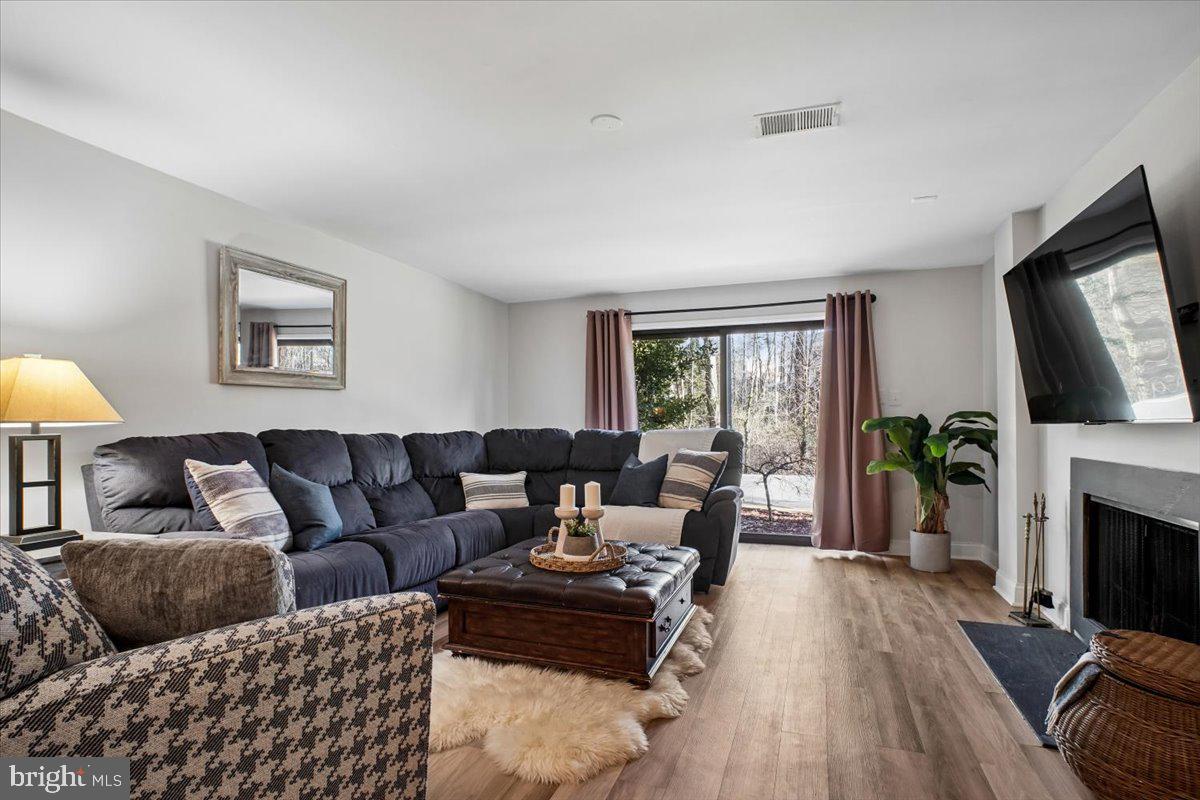 11514 Sunder Court Reston, VA 20190 - Photo 37 of 81 a living room with furniture a fireplace and a flat screen tv