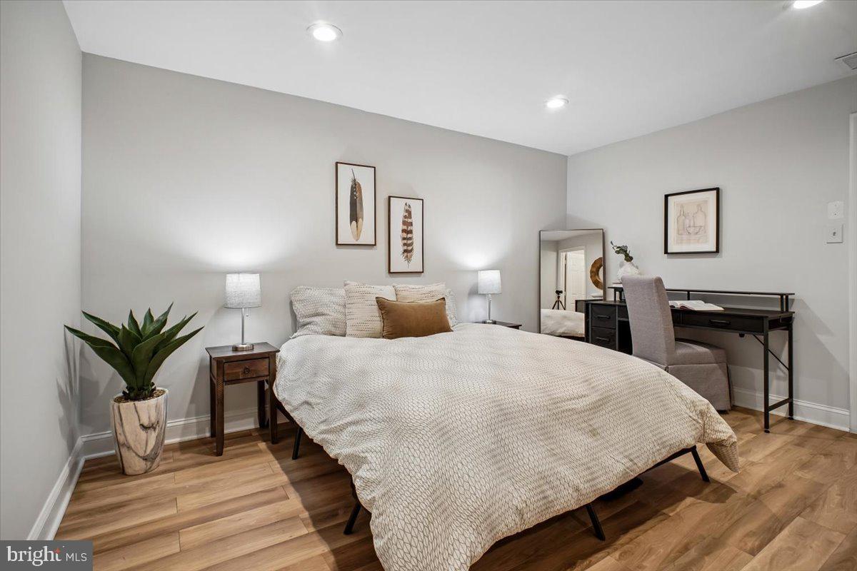 11514 Sunder Court Reston, VA 20190 - Photo 41 of 81 a spacious bedroom with a bed and a potted plant on the dresser
