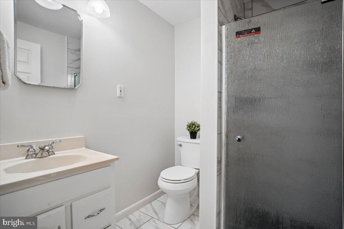 11514 Sunder Court Reston, VA 20190 - Photo 43 of 81 a bathroom with a granite countertop toilet a sink and mirror