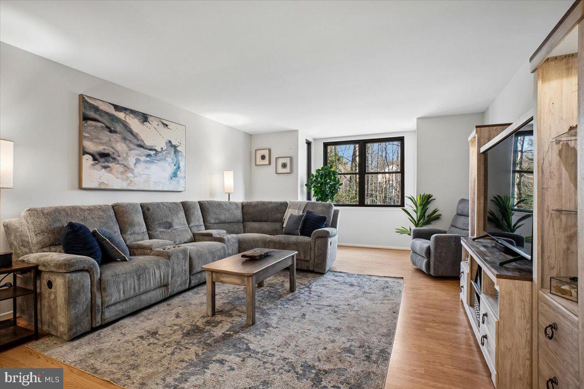 11514 Sunder Court Reston, VA 20190 - Photo 5 of 81 a living room with furniture a flat screen tv and a floor to ceiling window