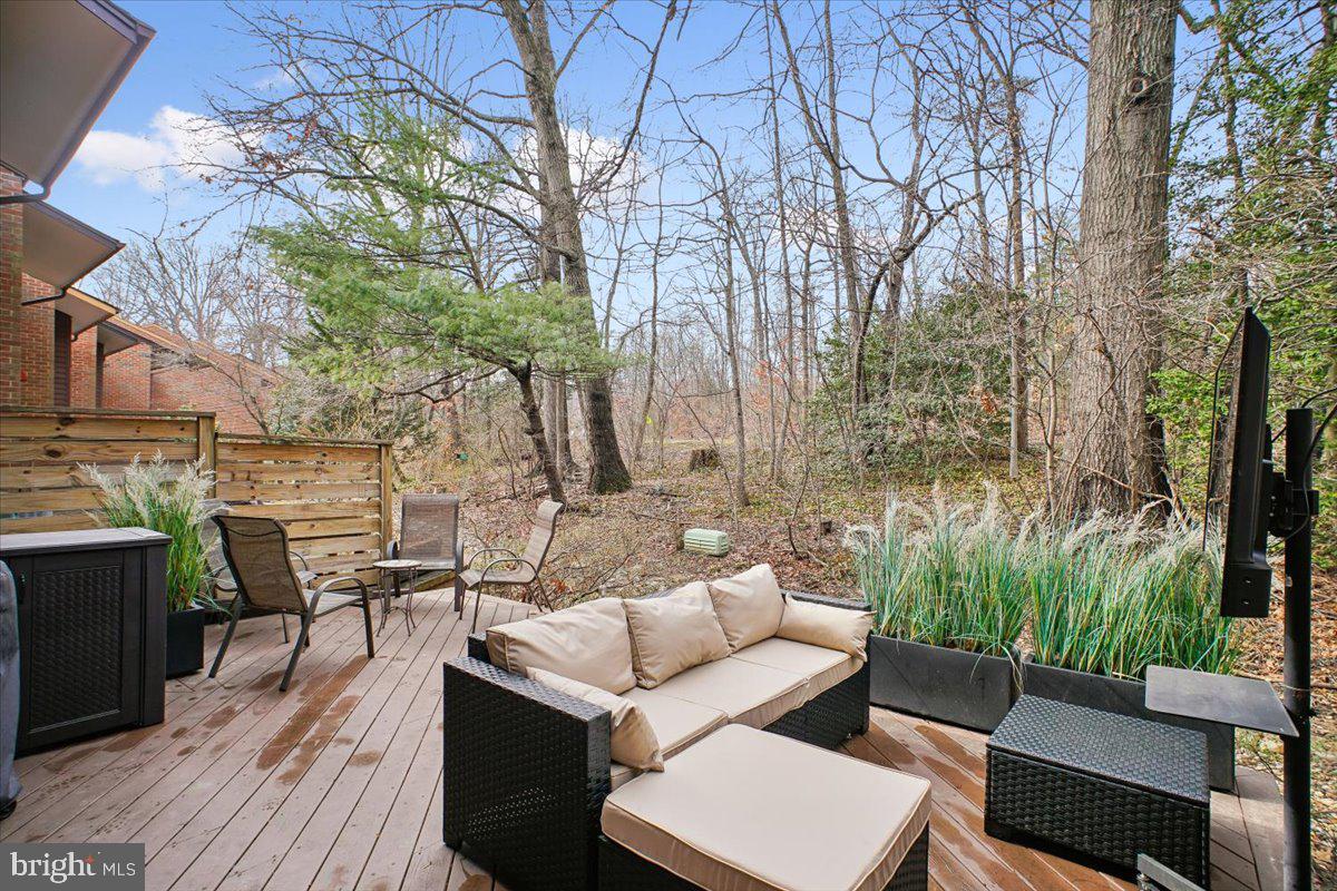 11514 Sunder Court Reston, VA 20190 - Photo 52 of 81 a view of a patio with couches and table and chairs with wooden floor and fence