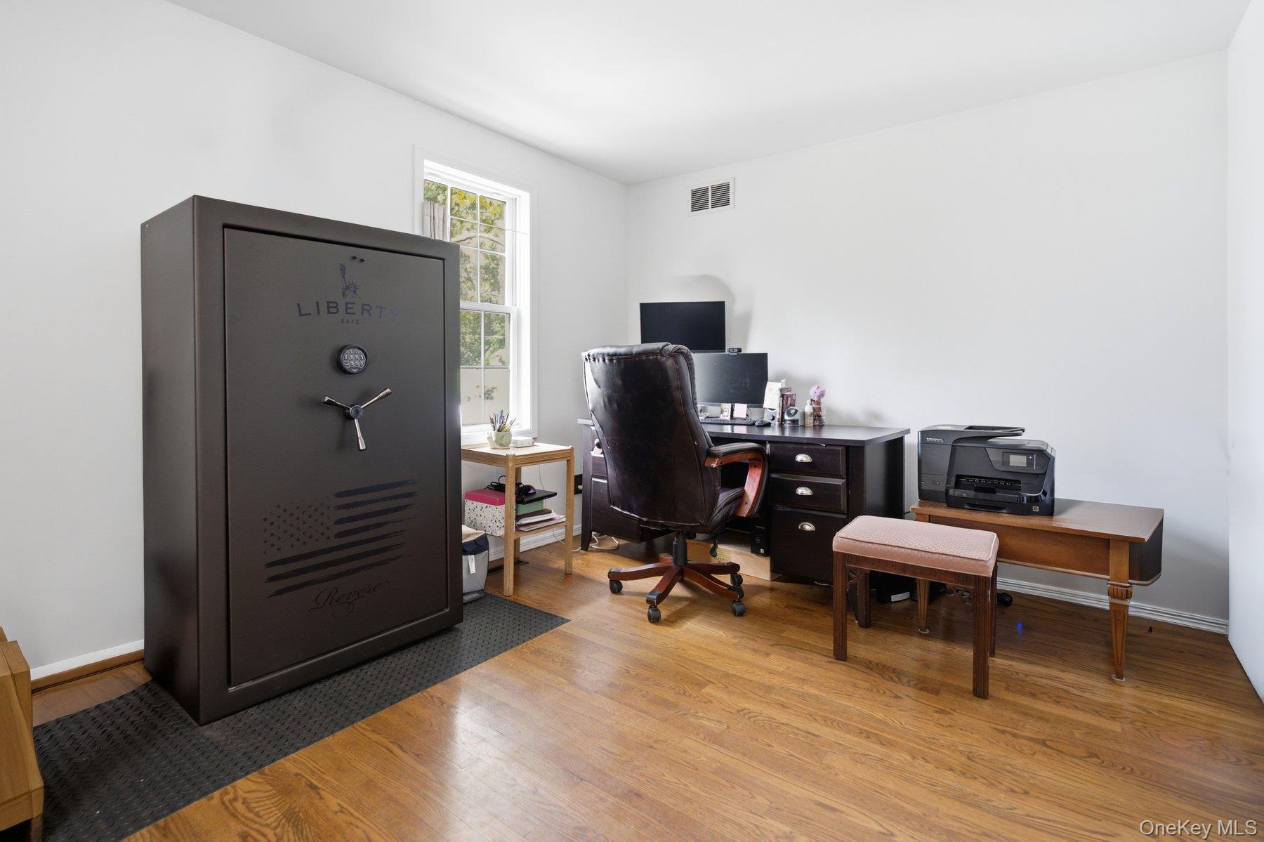 81 Beach Road Wading River, NY 11792 - Photo 10 of 25 a view of a workspace with furniture and wooden floor
