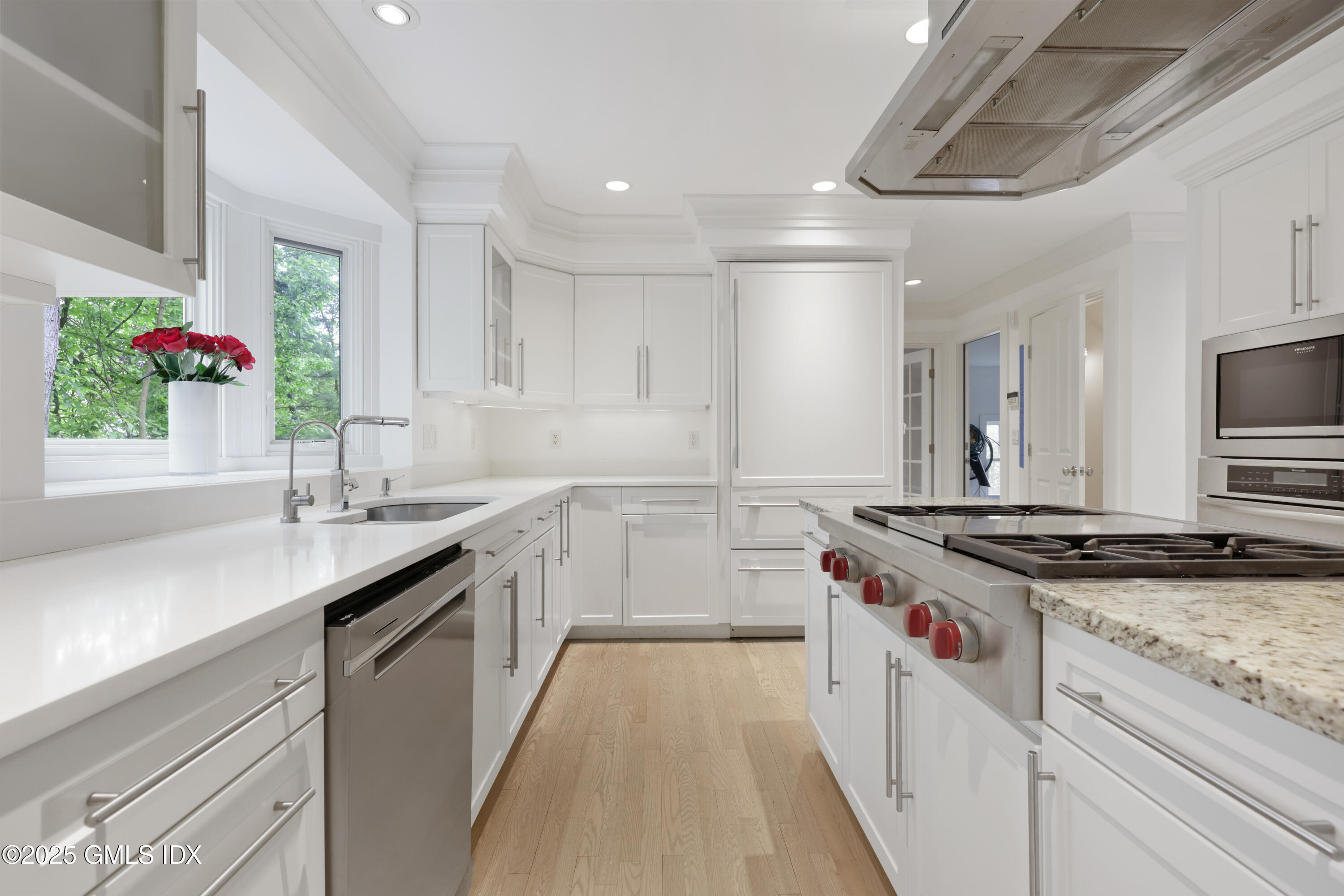 29 Griffith Road Riverside, CT 06878 - Photo 7 of 25 a kitchen with granite countertop a sink stove and cabinets