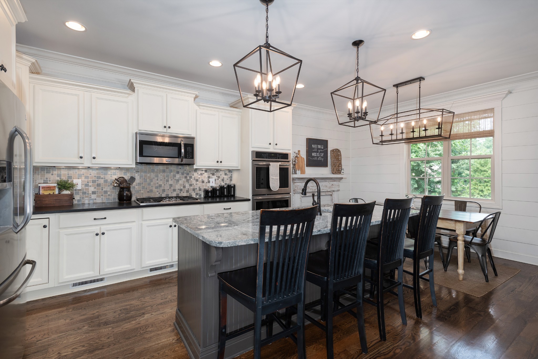 209 Ridgeview Preserve Drive Mount Juliet, TN 37122 - Photo 7 of 46 a open kitchen with stainless steel appliances granite countertop a dining table chairs refrigerator and microwave