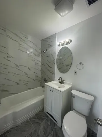 a bathroom with a toilet a sink and bathtub