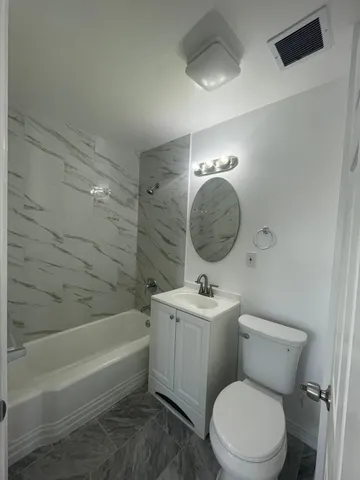 a bathroom with a toilet a sink and bathtub
