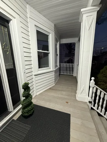 a view of porch with wooden floor and a window
