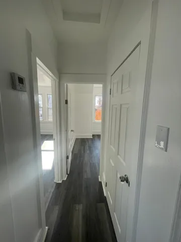 a view of hallway with wooden floor