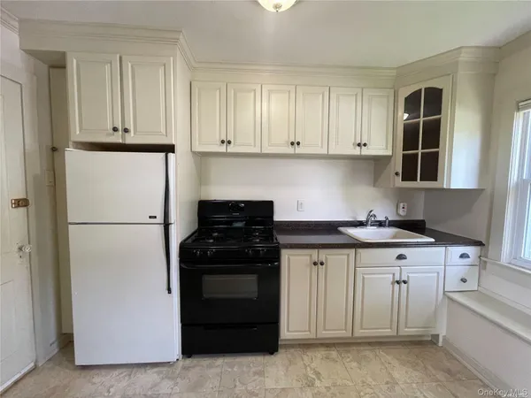 a kitchen with stainless steel appliances granite countertop a stove and a refrigerator