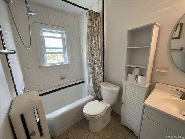 a white toilet sitting next to a bath tub