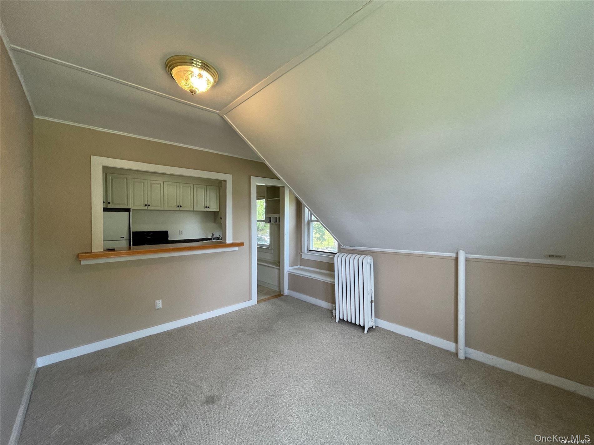 293 West Shore Road, Unit 4 Huntington, NY 11743 - Photo 6 of 13 a view of a livingroom with an empty space and a window