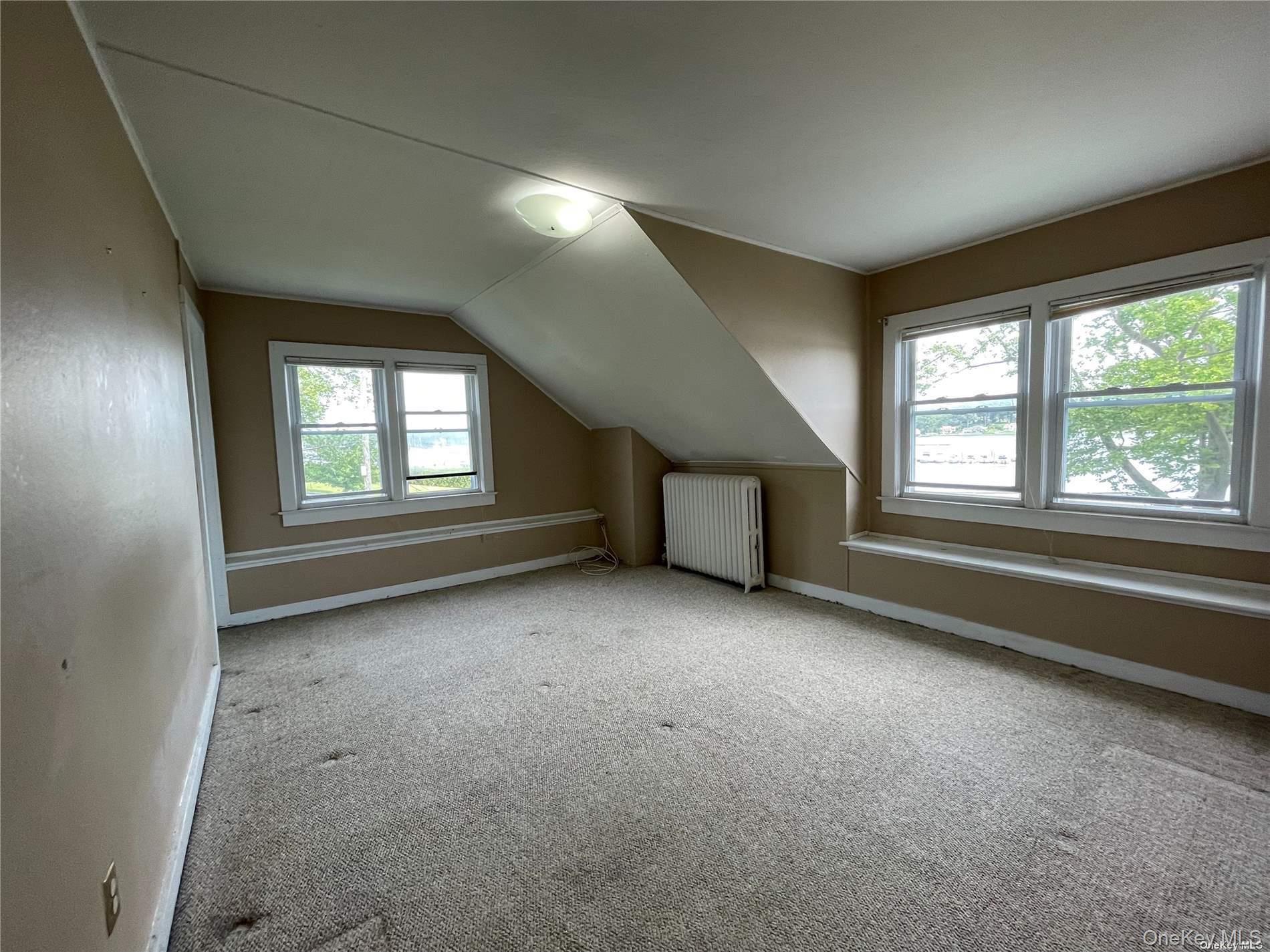 293 West Shore Road, Unit 4 Huntington, NY 11743 - Photo 10 of 13 an empty room with windows and closet