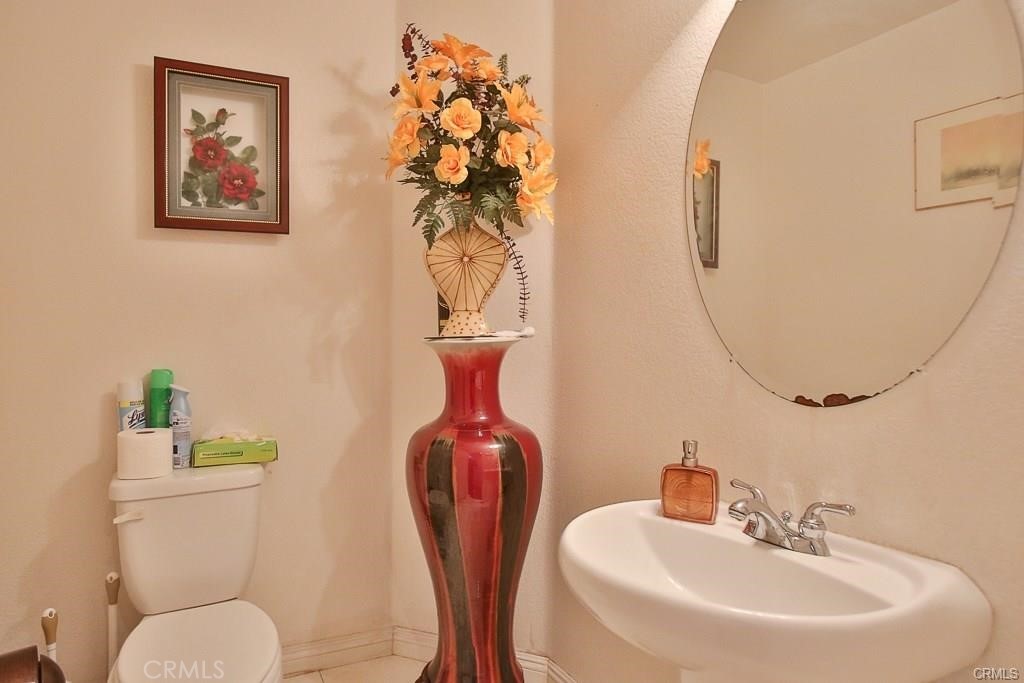 6302 Lavender Way Westminster, CA 92683 - Photo 12 of 38 a bathroom with a toilet sink and mirror