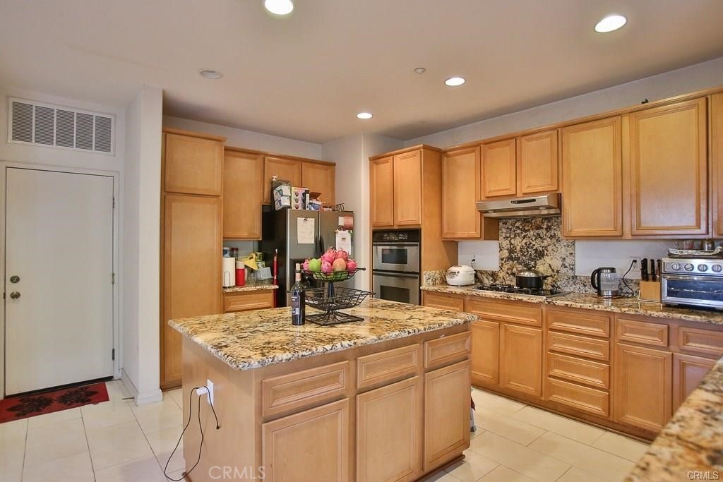 6302 Lavender Way Westminster, CA 92683 - Photo 14 of 38 a kitchen with a stove a sink a refrigerator and cabinets