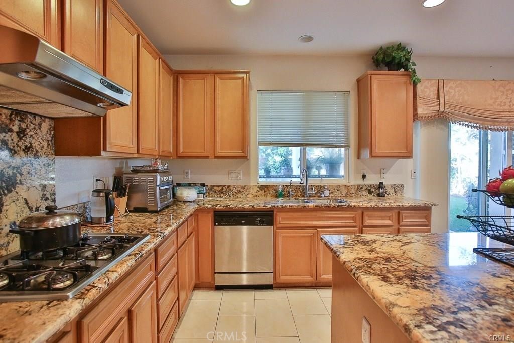 6302 Lavender Way Westminster, CA 92683 - Photo 15 of 38 a kitchen with stainless steel appliances granite countertop a stove a sink dishwasher and a refrigerator