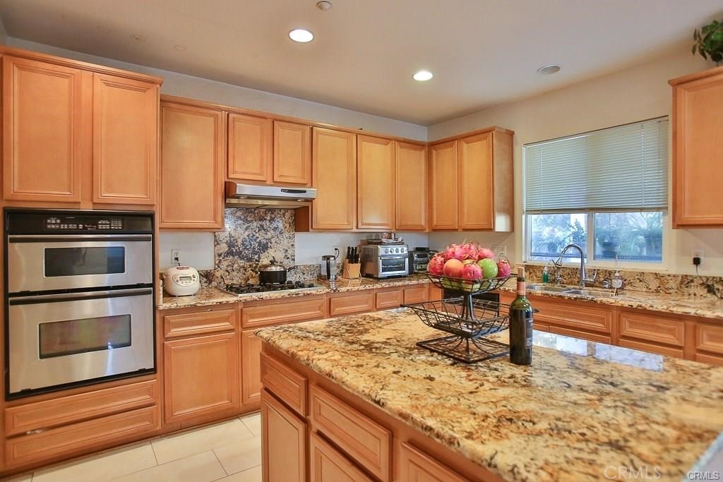6302 Lavender Way Westminster, CA 92683 - Photo 16 of 38 a kitchen with stainless steel appliances granite countertop a stove sink and cabinets